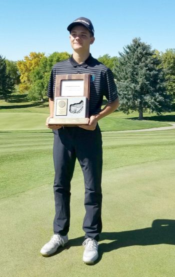 jarom golf with trophy for region win 1